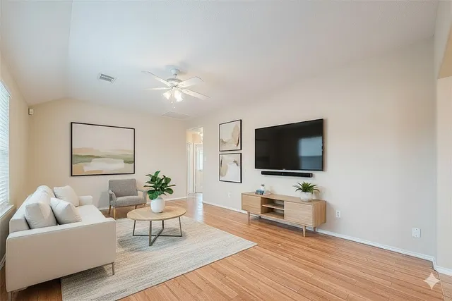 a living room with furniture and a flat screen tv