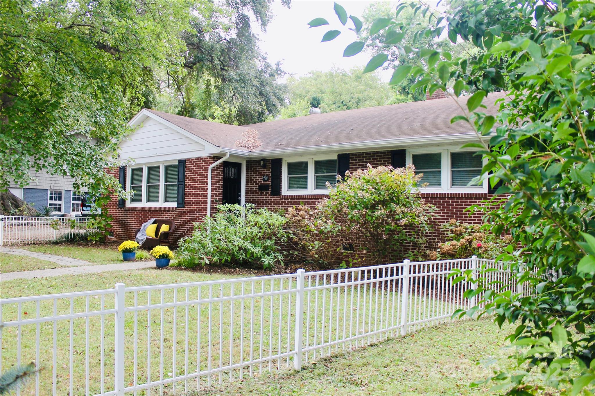 a front view of a house with a garden