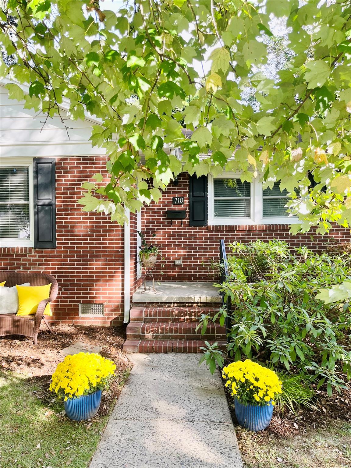 710 Neil Street Gastonia, NC 28052 - Photo 2 of 13 a view of a swimming pool with some potted plants and a fountain