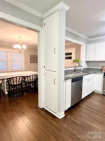 a kitchen with a sink a window and stainless steel appliances