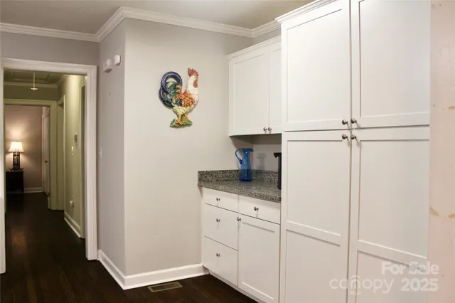 a bedroom with a bed chandelier and a window