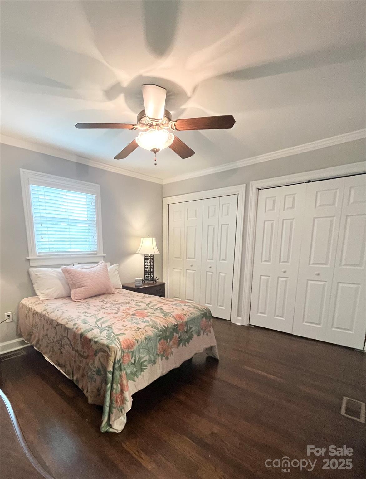 710 Neil Street Gastonia, NC 28052 - Photo 9 of 13 a bedroom with a bed chandelier and a window