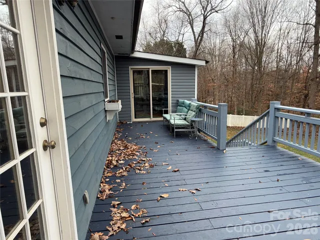 a view of a house with wooden fence