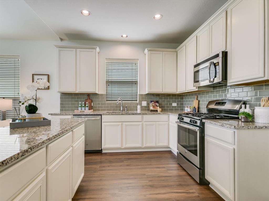 736 Bonnet Boulevard Georgetown, TX 78628 - Photo 5 of 27 a kitchen with stainless steel appliances granite countertop a stove sink and cabinets