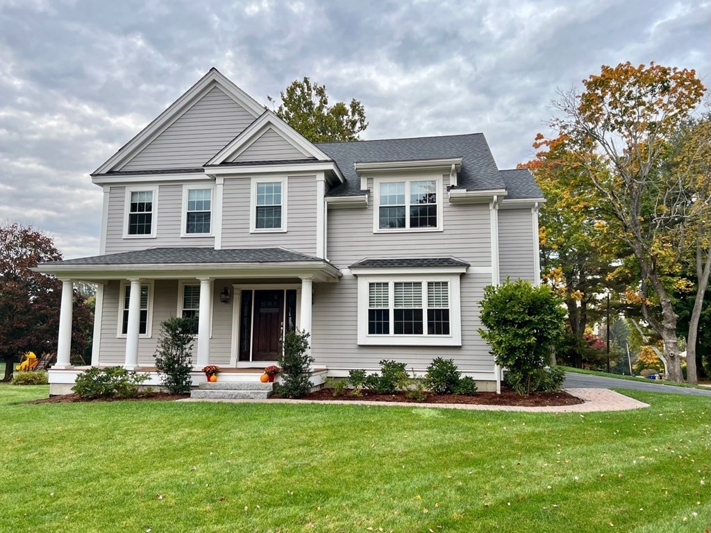 427 Davis Road Bedford, MA 01730 - Photo 1 of 42 a front view of a house with a garden