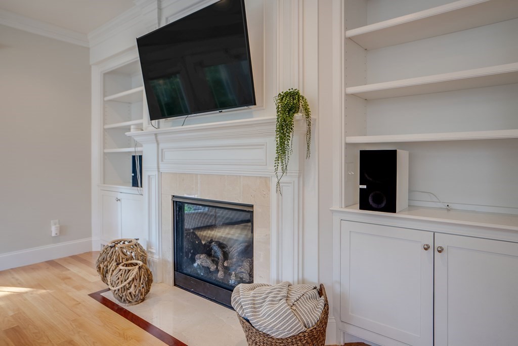 427 Davis Road Bedford, MA 01730 - Photo 12 of 42 a living room with furniture and a fireplace