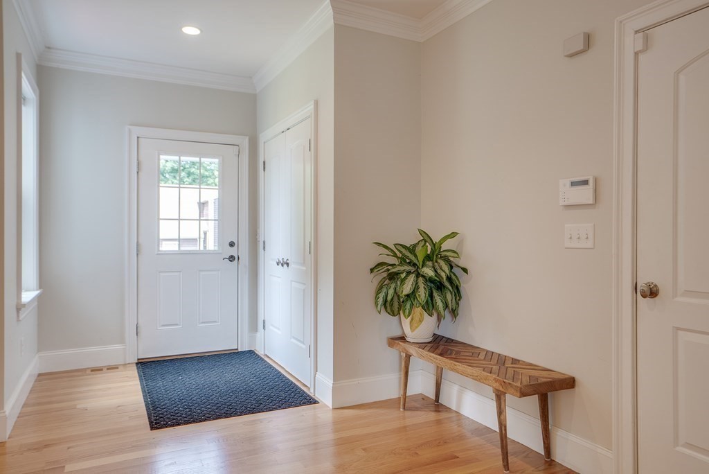 427 Davis Road Bedford, MA 01730 - Photo 16 of 42 a view of a hallway with wooden floor and a potted plant