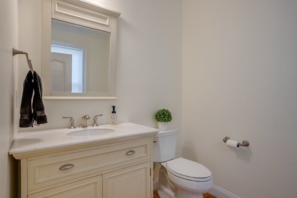 427 Davis Road Bedford, MA 01730 - Photo 17 of 42 a bathroom with a granite countertop toilet sink and mirror