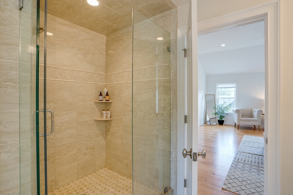 427 Davis Road Bedford, MA 01730 - Photo 23 of 42 a bathroom with a glass shower door a sink and a mirror