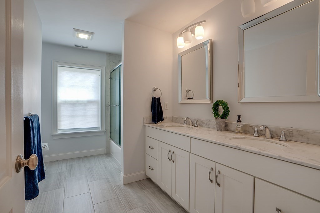 427 Davis Road Bedford, MA 01730 - Photo 28 of 42 a bathroom with a sink and a mirror