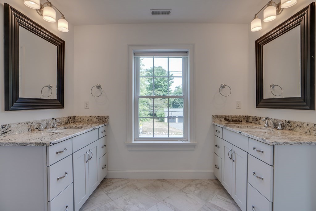 427 Davis Road Bedford, MA 01730 - Photo 33 of 42 a bathroom with a double vanity sink window and mirror