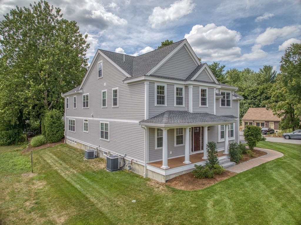 427 Davis Road Bedford, MA 01730 - Photo 38 of 42 a aerial view of a house next to a big yard and large trees