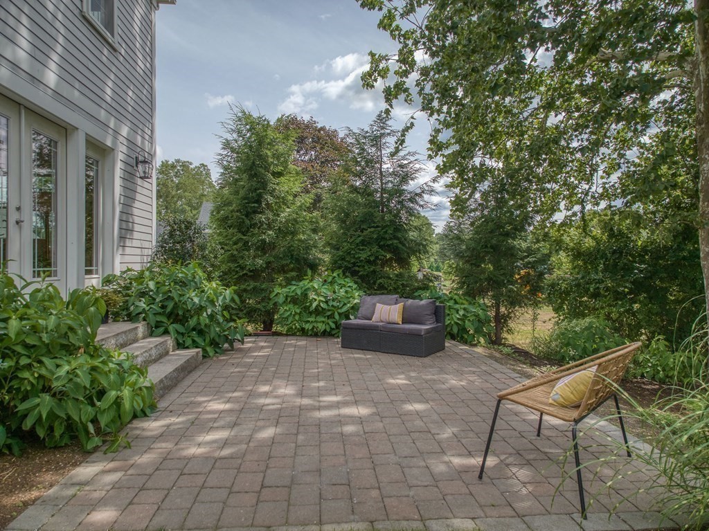 427 Davis Road Bedford, MA 01730 - Photo 40 of 42 a view of a chairs and table in a backyard