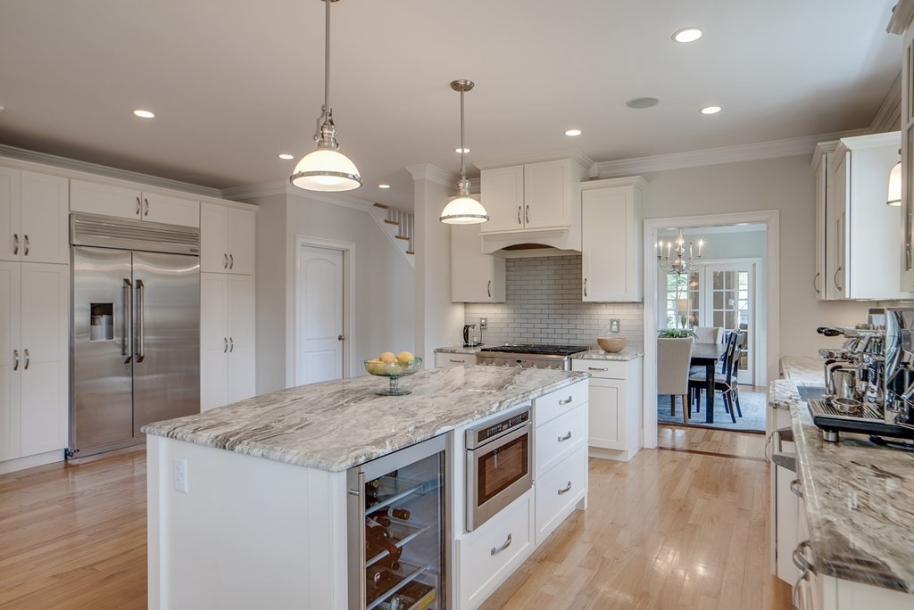 427 Davis Road Bedford, MA 01730 - Photo 4 of 42 a kitchen with a stove a sink a refrigerator and a center island