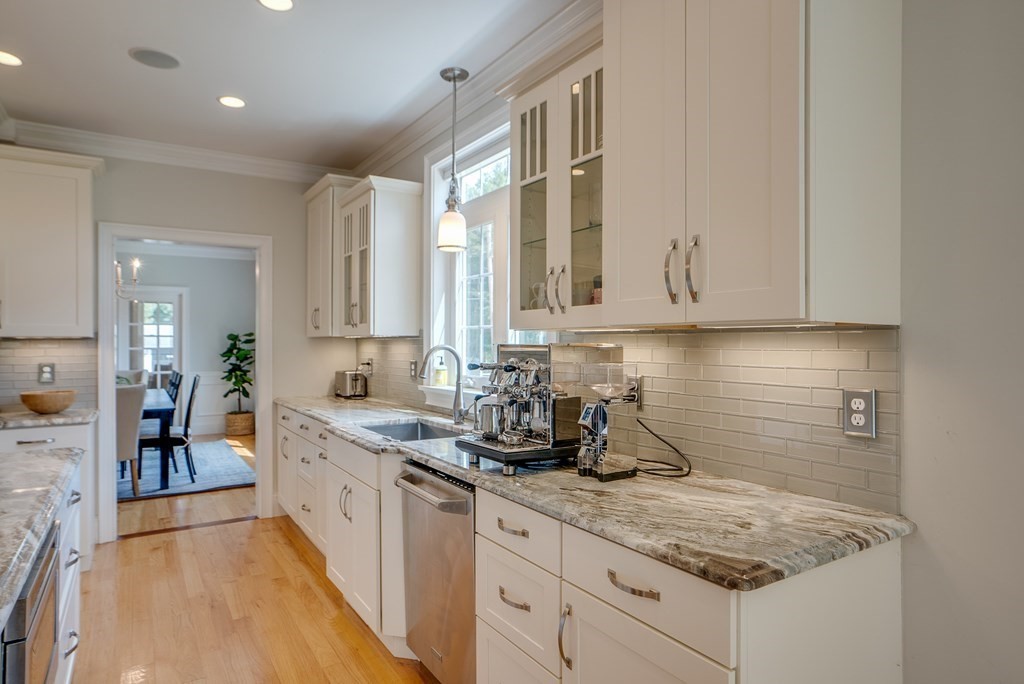 427 Davis Road Bedford, MA 01730 - Photo 5 of 42 a kitchen with stainless steel appliances granite countertop a sink stove and cabinets