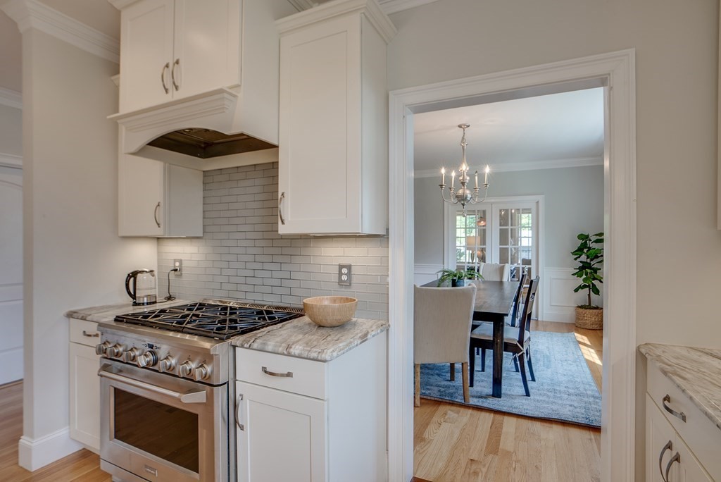 427 Davis Road Bedford, MA 01730 - Photo 6 of 42 a kitchen with a stove and white cabinets