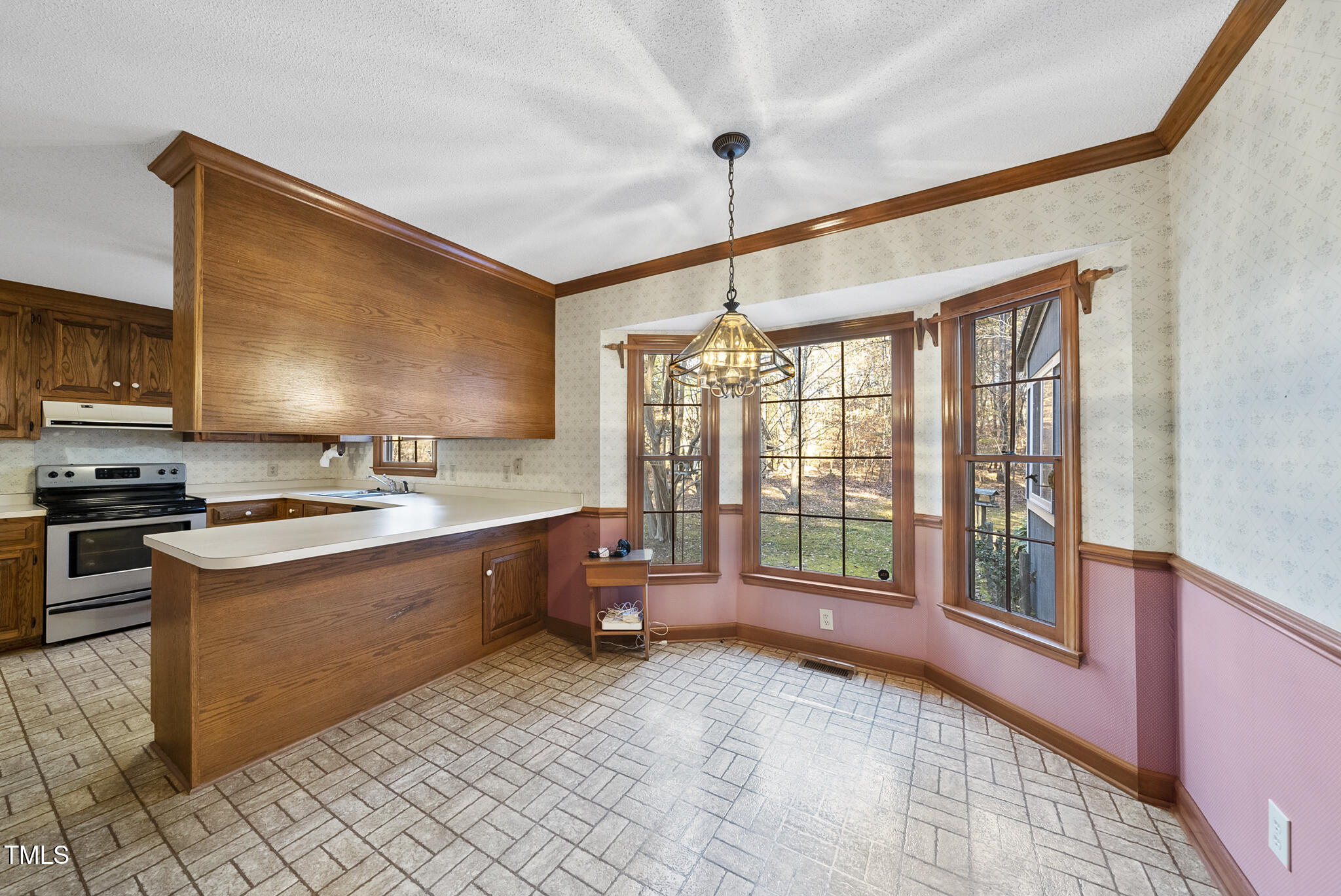 12012 Strickland Road Raleigh, NC 27613 - Photo 19 of 45 a large kitchen with kitchen island granite countertop a large window