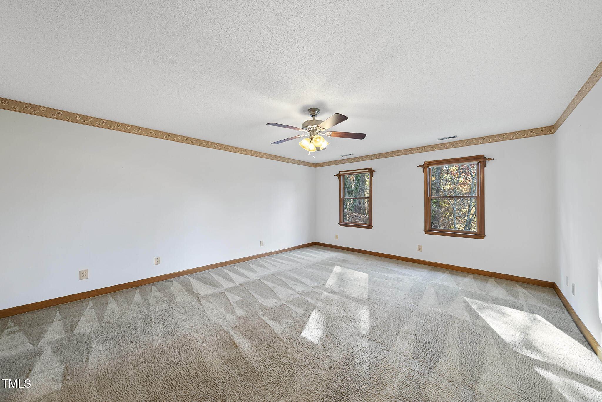 12012 Strickland Road Raleigh, NC 27613 - Photo 27 of 45 a view of an empty room with a window