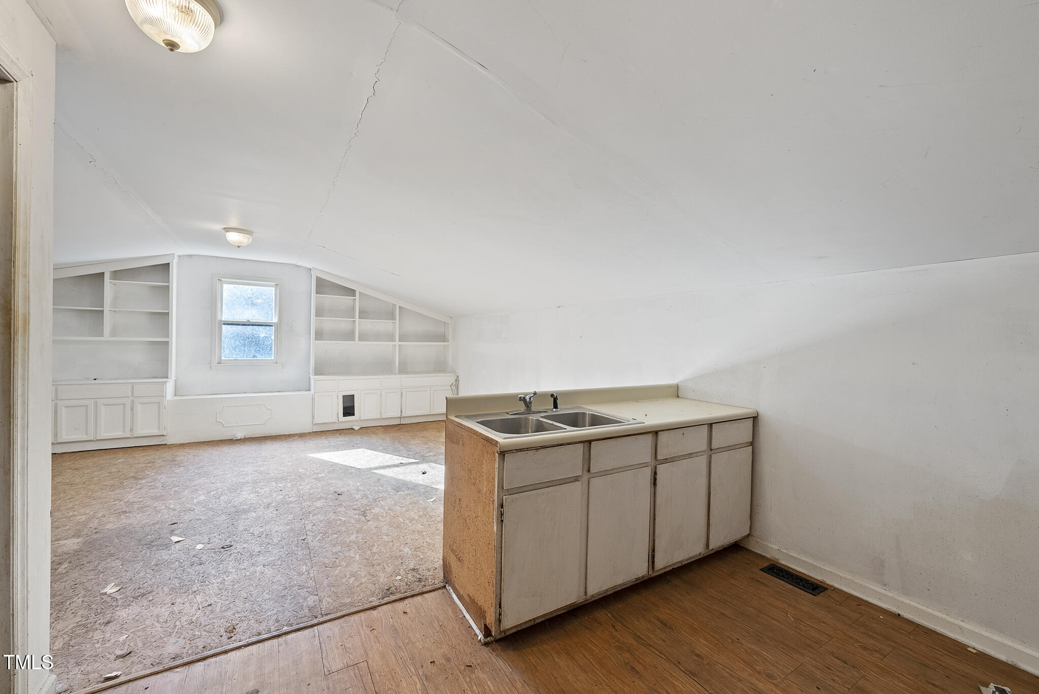 12012 Strickland Road Raleigh, NC 27613 - Photo 40 of 45 a view of a kitchen with wooden floor and cabinets