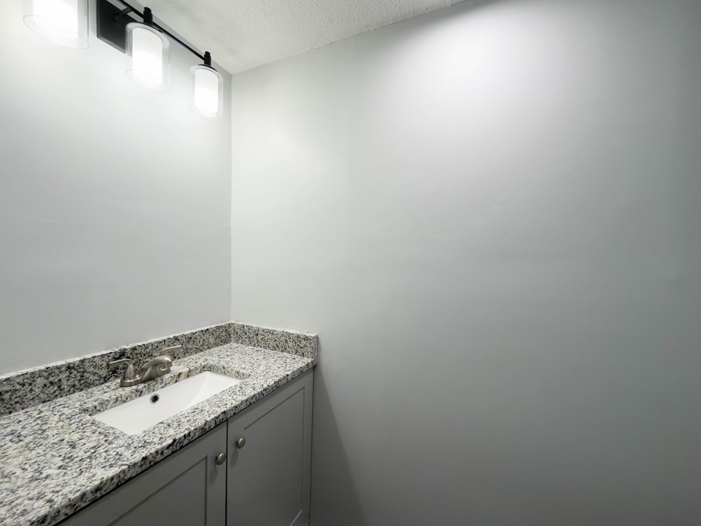 4312 Old Macon Road, Unit 56 Columbus, GA 31907 - Photo 17 of 19 a bathroom with a granite countertop sink and vanity