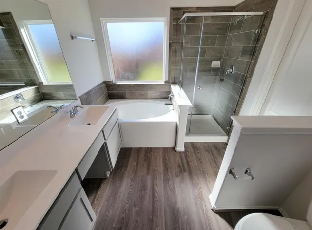 a bathroom with a tub sink and mirror