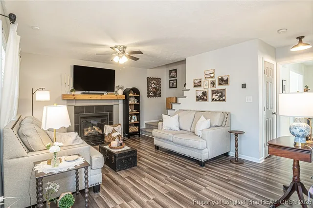 a living room with furniture ceiling fan and a rug