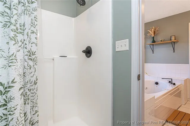 a bathroom with a tub a sink and a window