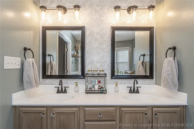a white toilet sitting next to a shower curtain and a sink