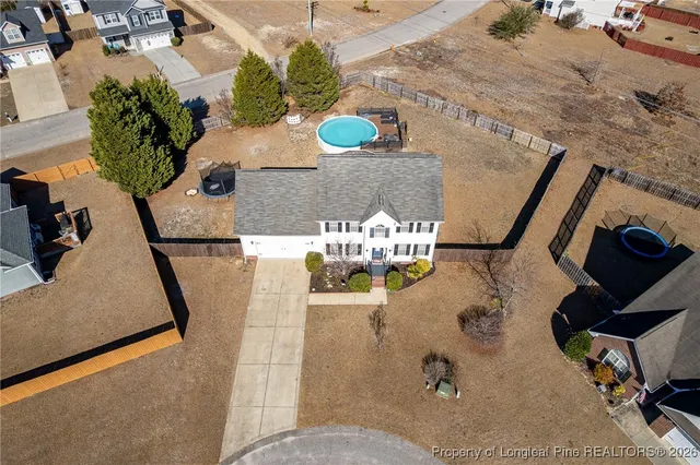 an aerial view of a house with outdoor space