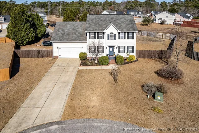 a view of a house with swimming pool and sitting area