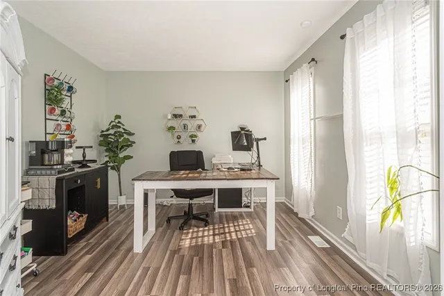 a view of a dining room with furniture large windows and wooden floor
