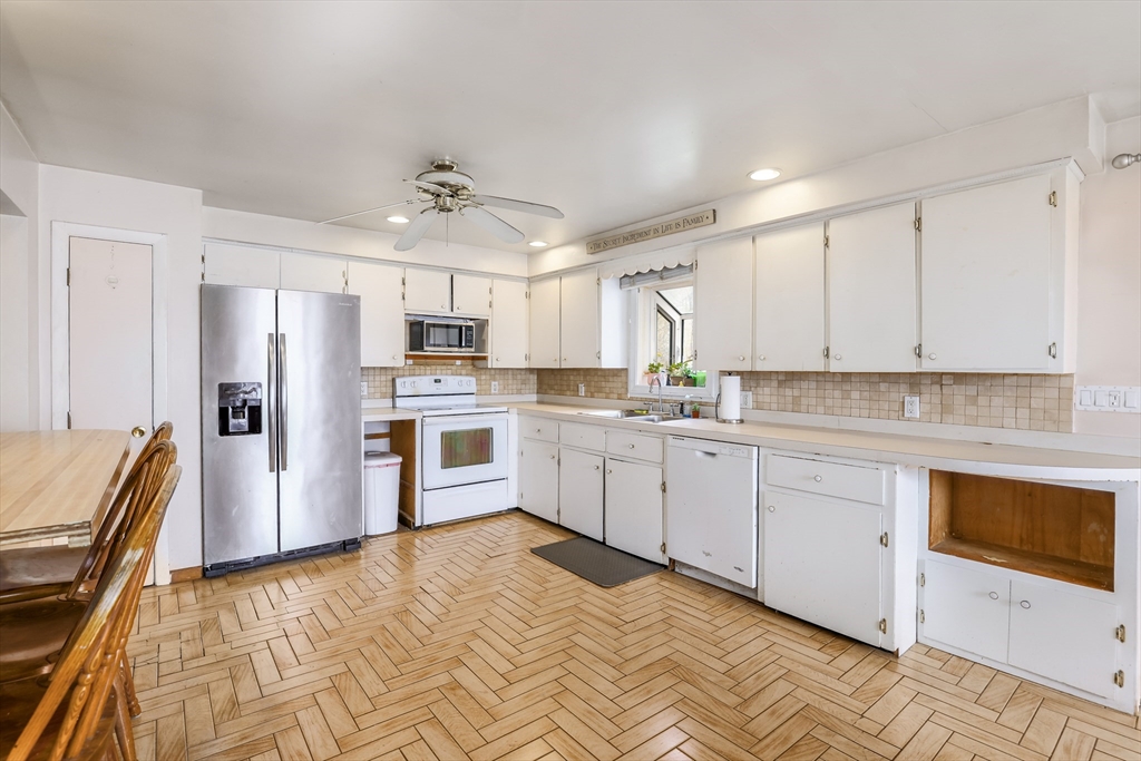 6 Lerner Drive Dudley, MA 01571 - Photo 11 of 22 a kitchen with stainless steel appliances granite countertop a refrigerator sink and white cabinets