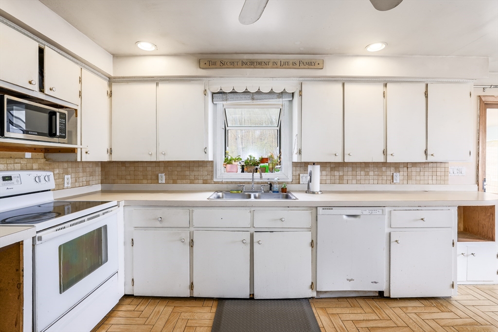 6 Lerner Drive Dudley, MA 01571 - Photo 12 of 22 a kitchen with white cabinets appliances and a sink