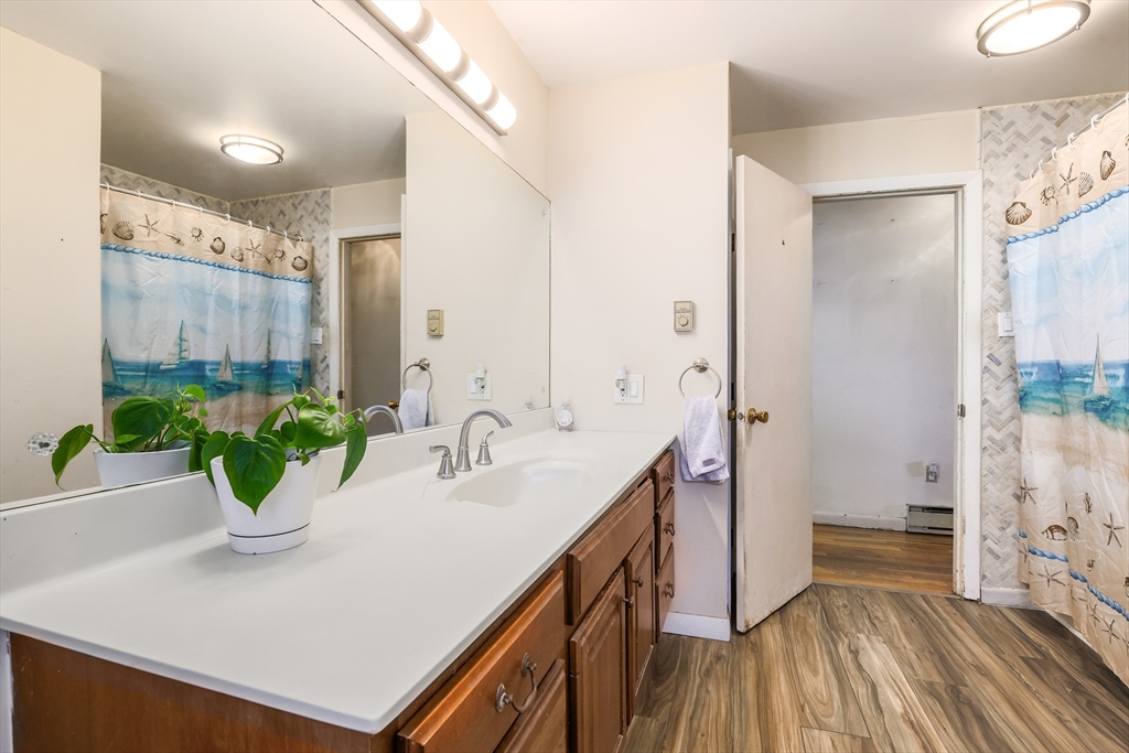 6 Lerner Drive Dudley, MA 01571 - Photo 13 of 22 a bathroom with a sink a mirror and a shower