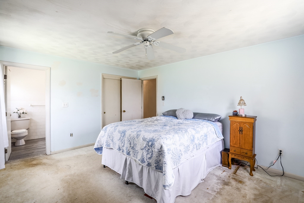 6 Lerner Drive Dudley, MA 01571 - Photo 15 of 22 a bedroom with a bed and a chandelier