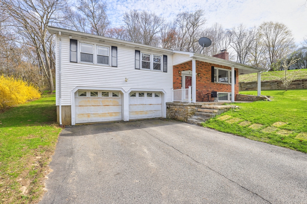 6 Lerner Drive Dudley, MA 01571 - Photo 2 of 22 a front view of a house with a yard and garage