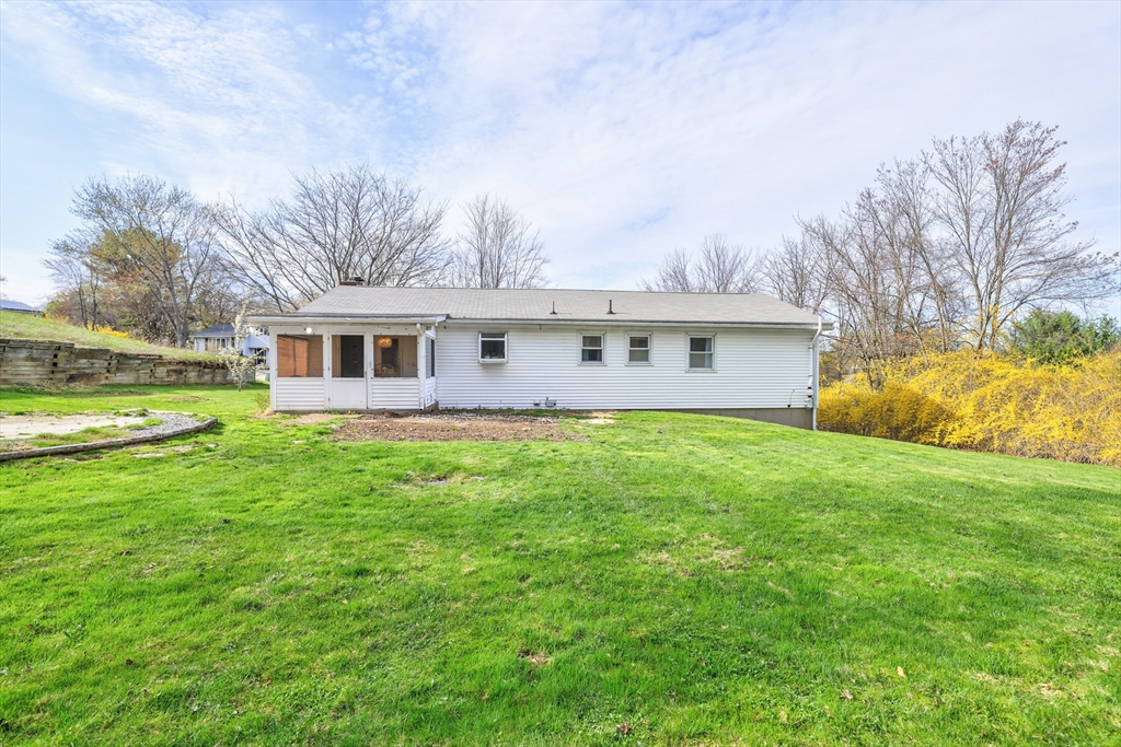 6 Lerner Drive Dudley, MA 01571 - Photo 5 of 22 a view of a house with a backyard