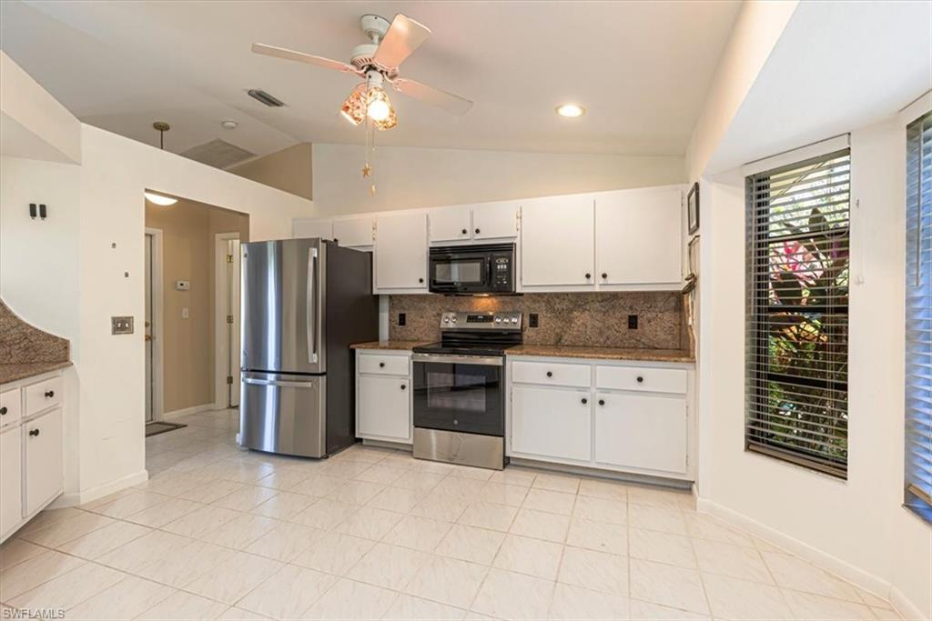 124 Versailles Circle Naples, FL 34112 - Photo 12 of 21 a kitchen with stainless steel appliances granite countertop a cabinets and a refrigerator