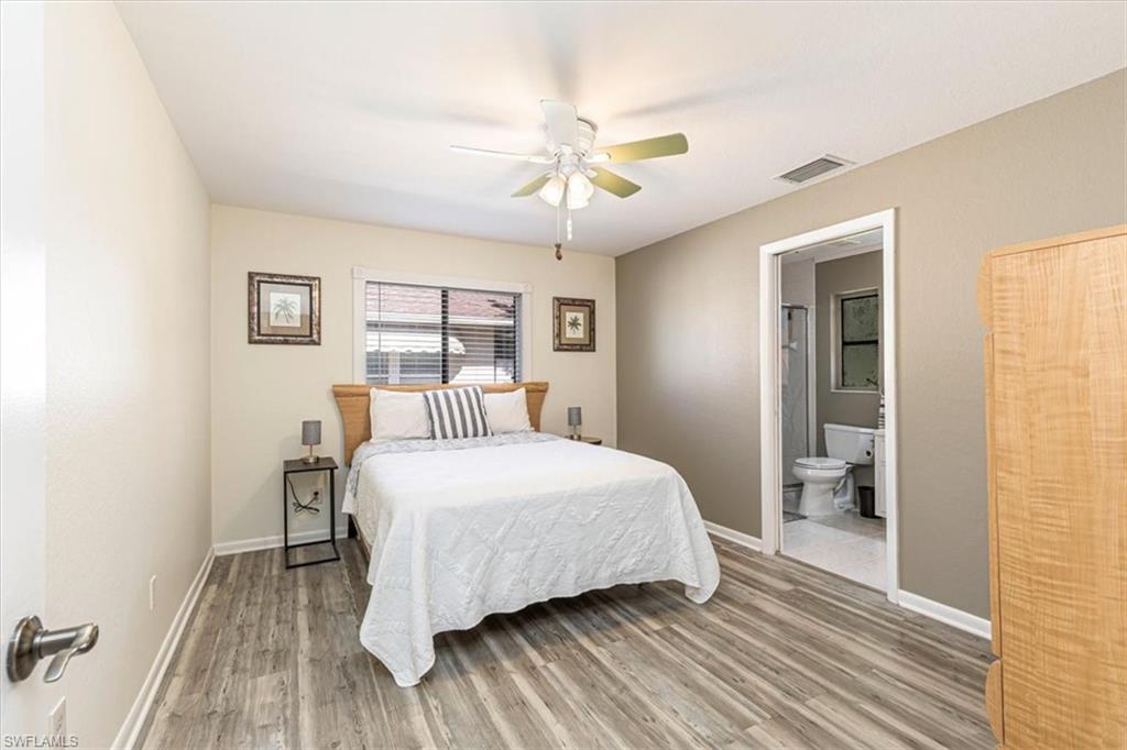 124 Versailles Circle Naples, FL 34112 - Photo 15 of 21 a bedroom with a bed and a walk in closet