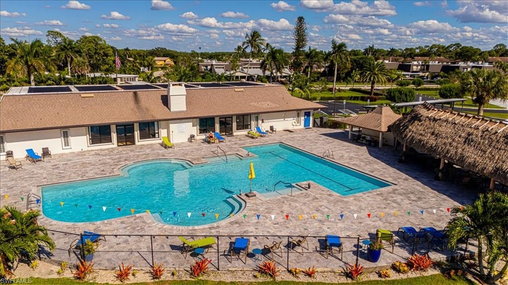 124 Versailles Circle Naples, FL 34112 - Photo 16 of 21 an aerial view of multiple houses with a yard