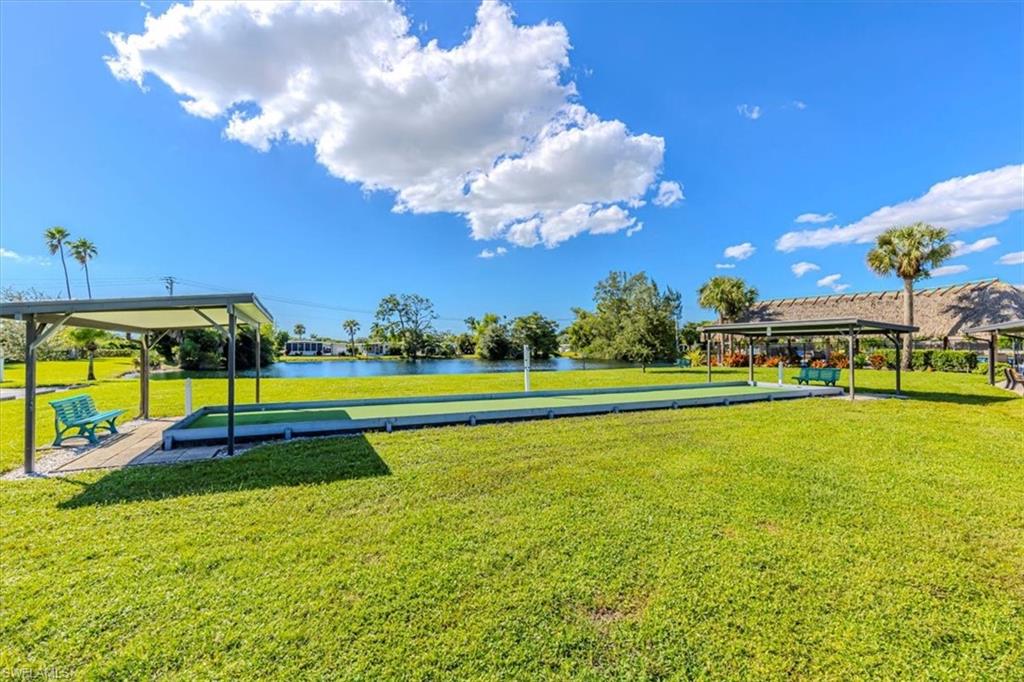 124 Versailles Circle Naples, FL 34112 - Photo 18 of 21 a view of a swimming pool with an outdoor space and seating area