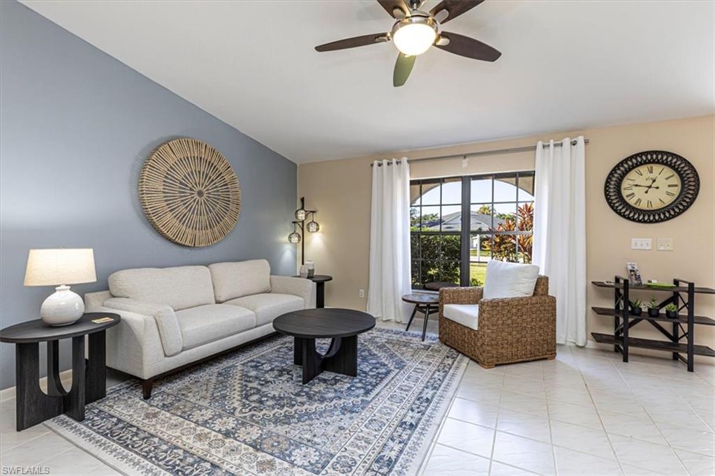 124 Versailles Circle Naples, FL 34112 - Photo 4 of 21 a living room with furniture a clock and a window