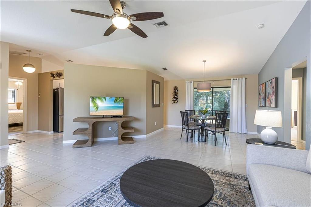 124 Versailles Circle Naples, FL 34112 - Photo 5 of 21 a living room with furniture and a flat screen tv