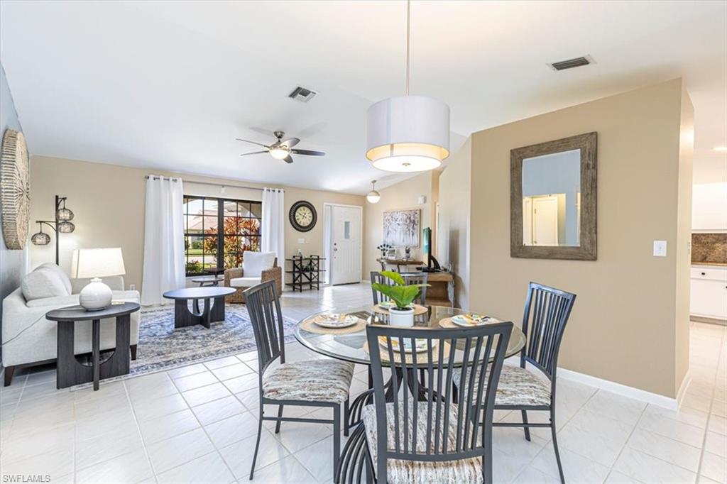 124 Versailles Circle Naples, FL 34112 - Photo 7 of 21 a view of a dining room with furniture and chandelier