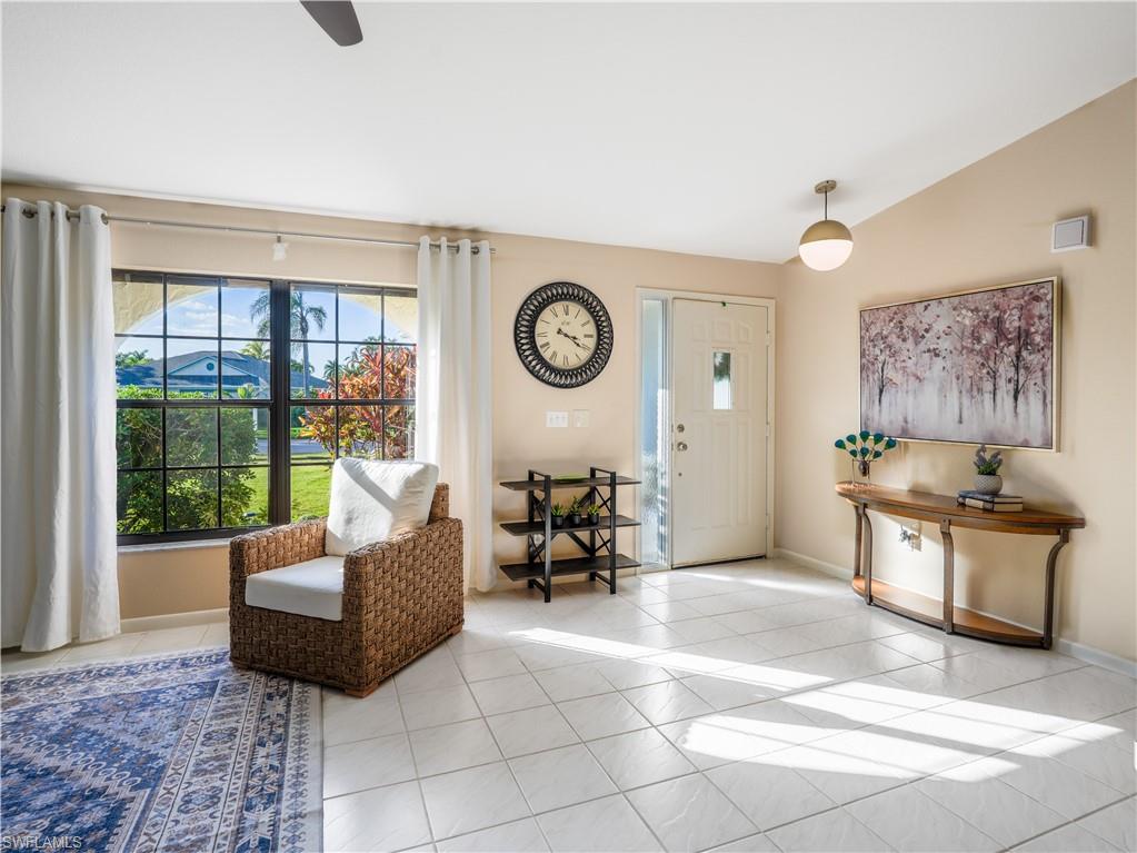 124 Versailles Circle Naples, FL 34112 - Photo 8 of 21 a living room with furniture and a large window