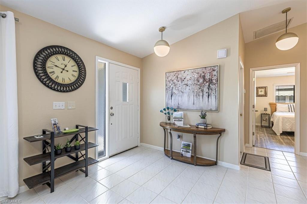 124 Versailles Circle Naples, FL 34112 - Photo 9 of 21 a view of a room with a table and a chair