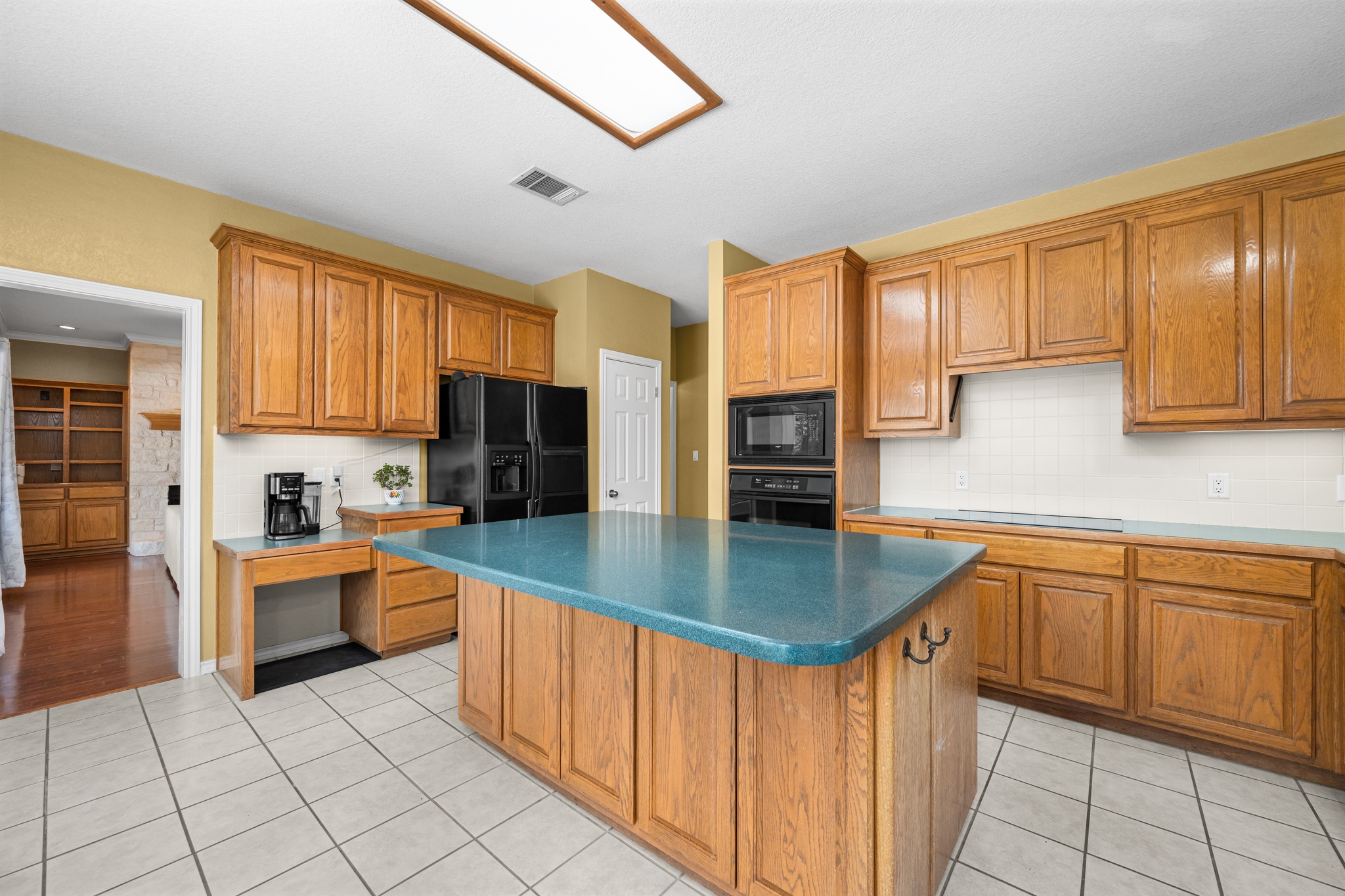 108 Thornwood Road Georgetown, TX 78628 - Photo 16 of 40 Central island with a vibrant countertop anchors this spacious kitchen, equipped with ample cabinetry.
