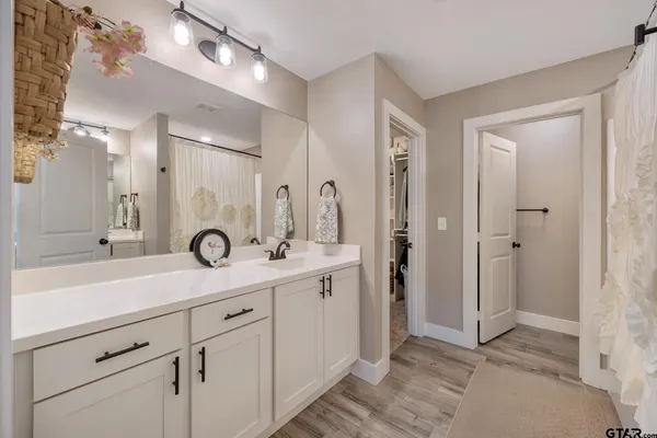 a bathroom with a double vanity sink and mirror