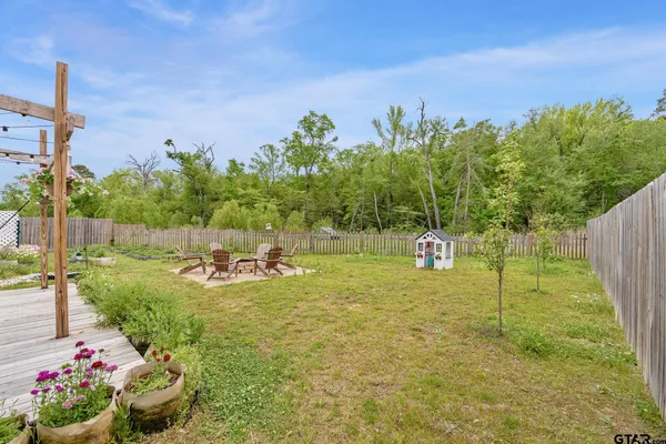 a view of a chairs and table in backyard
