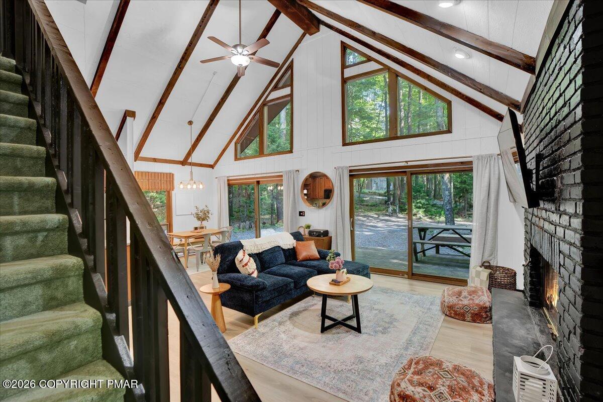 58 Sheffick Road, Unit E743 Gouldsboro, PA 18424 - Photo 2 of 44 a living room with furniture a rug a fireplace and a large window